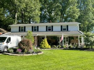 GRT Roofing helps homeowners with roof repairs and replacement at a well-kept family house.