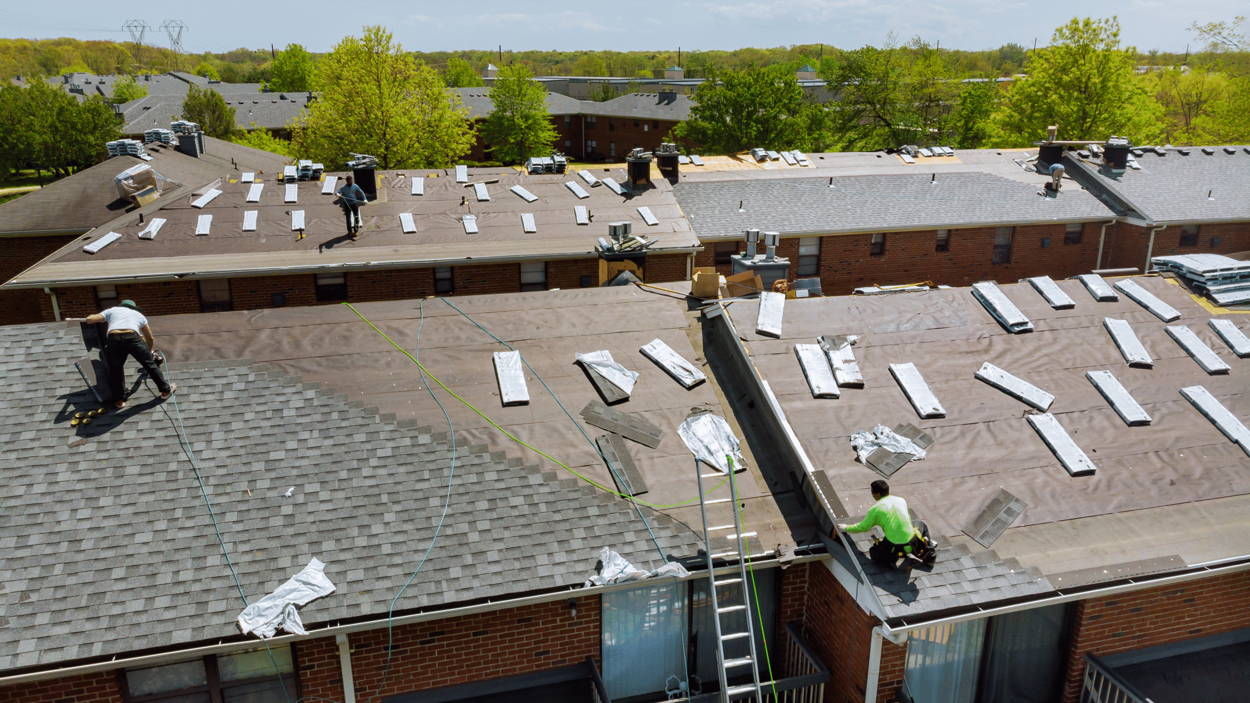 GRT Roofing team installs new roof on apartment building, showing commercial roofing expertise