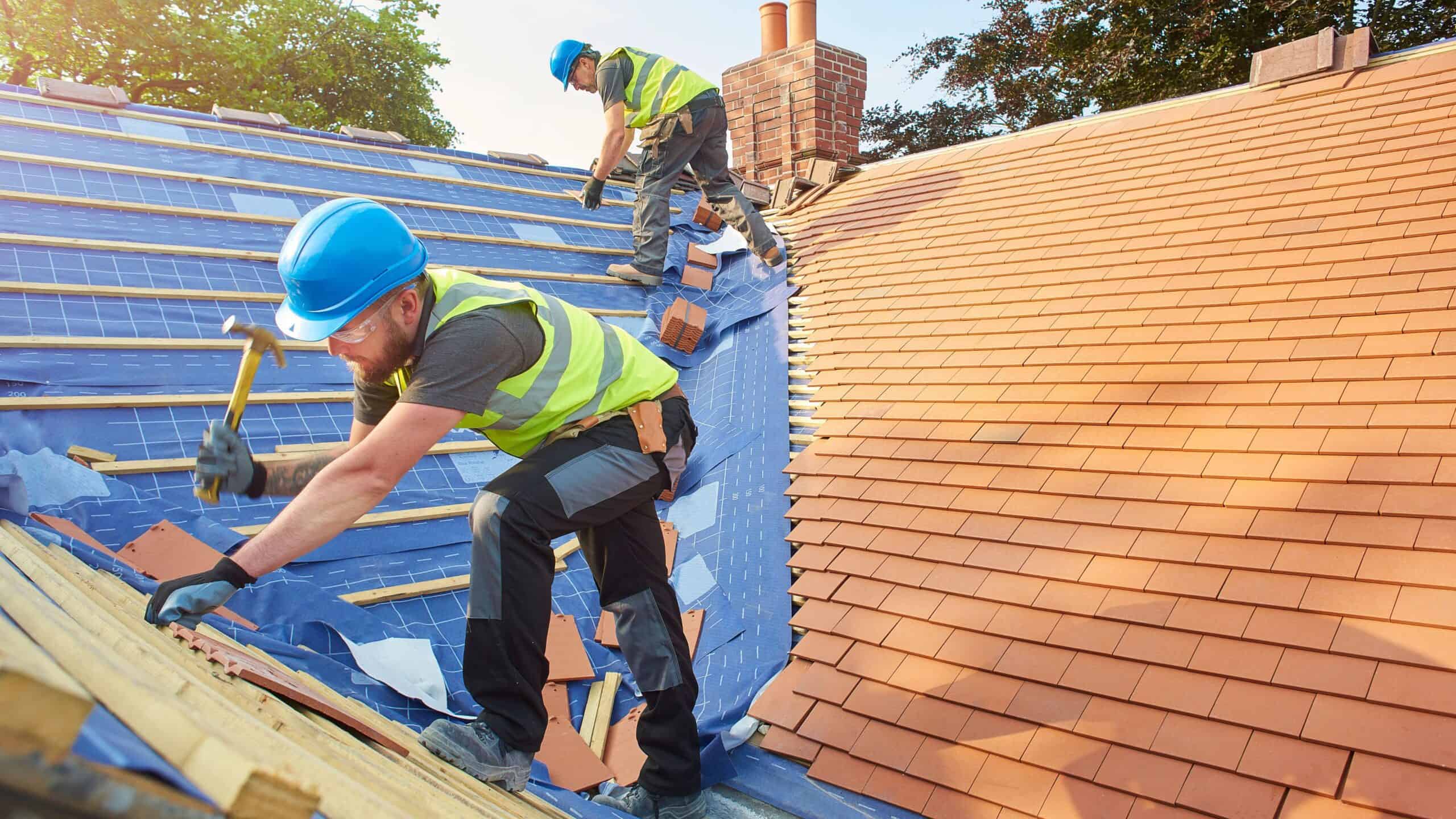 GRT Roofing workers install new roof tiles with skilled teamwork