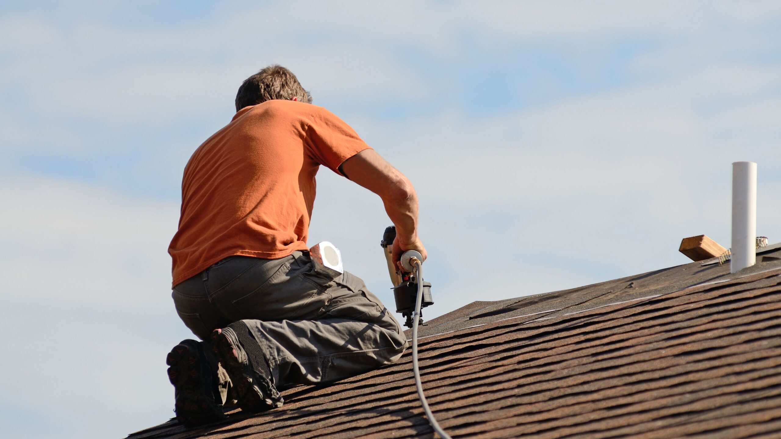 GRT Roofing expert repairs storm-damaged roofs with skill and care